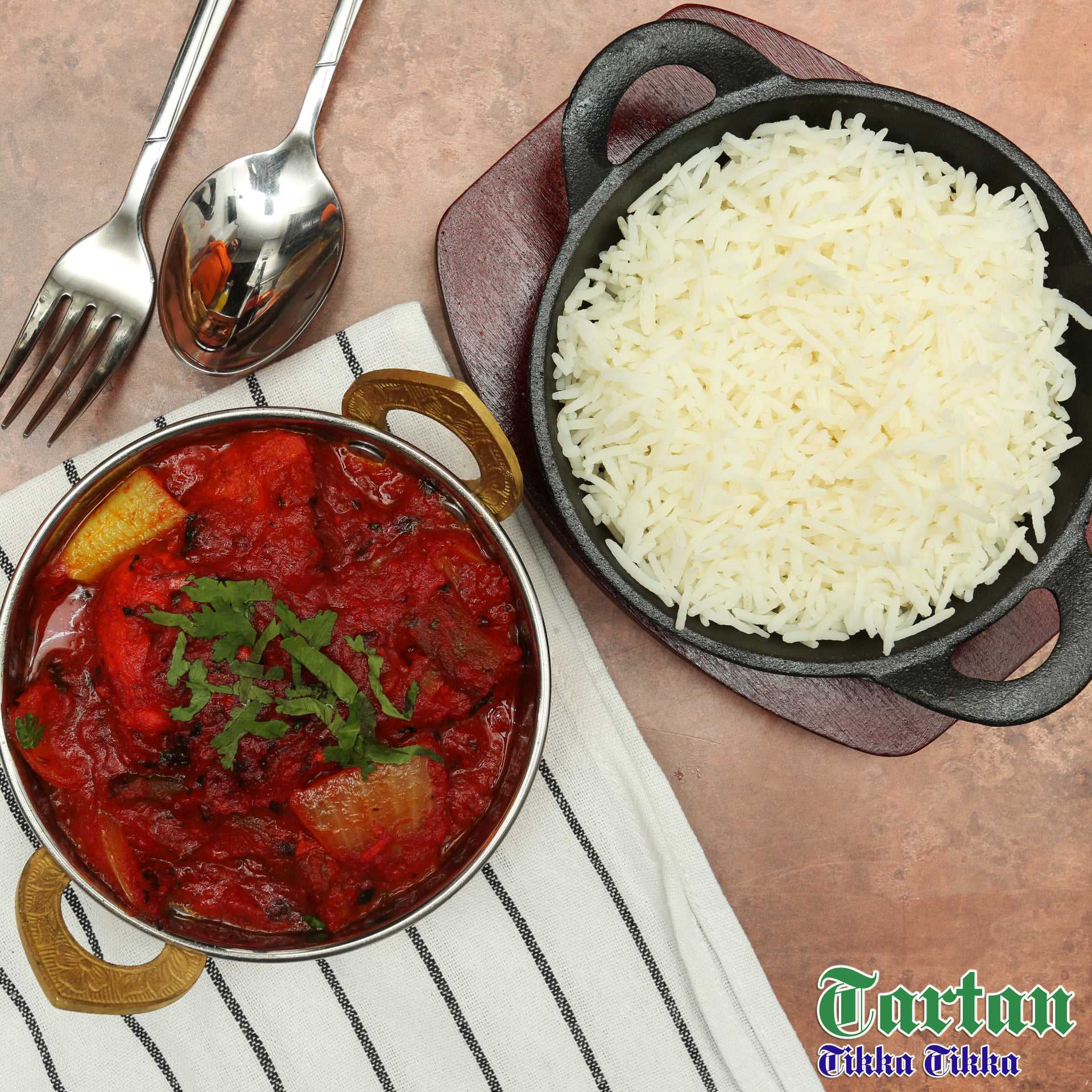 a pot of curry and a pot of rice with spoon and fork beside, served at Tartan Tikka Tikka Alloa